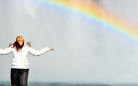 Lady in front of rainbow