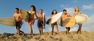 Six people with surfboards on beach