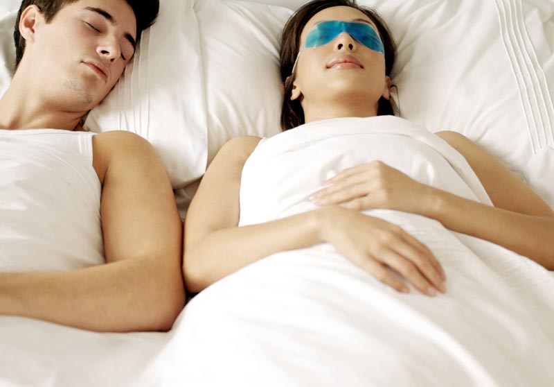 Couple asleep in bed